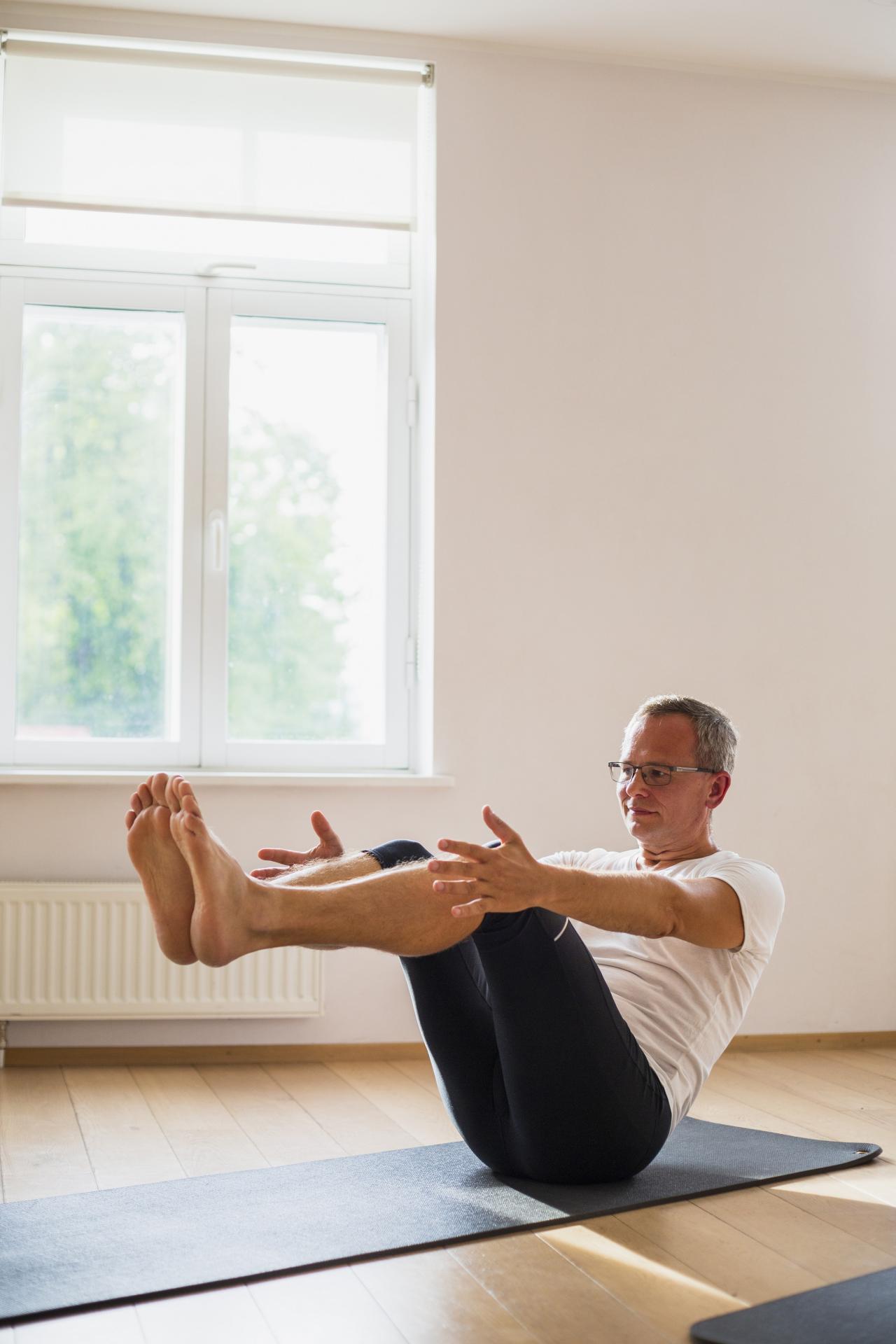 Senior man doing exercises gym